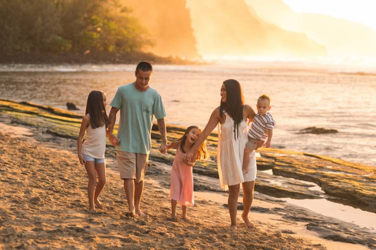 Family walking on beach in Maui