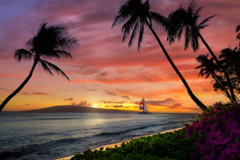 Maui at sunset with sailboat on water