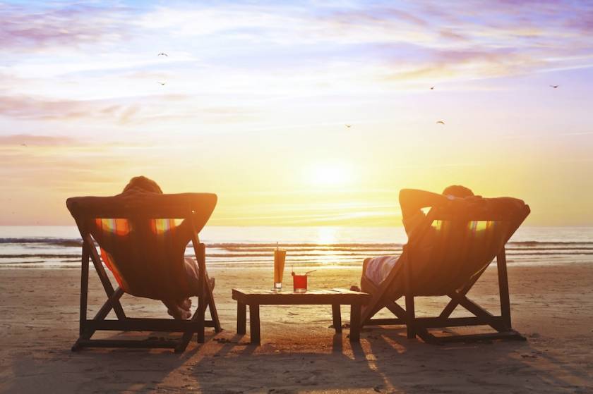 couple lounging in beach chairs at sunset in Maui